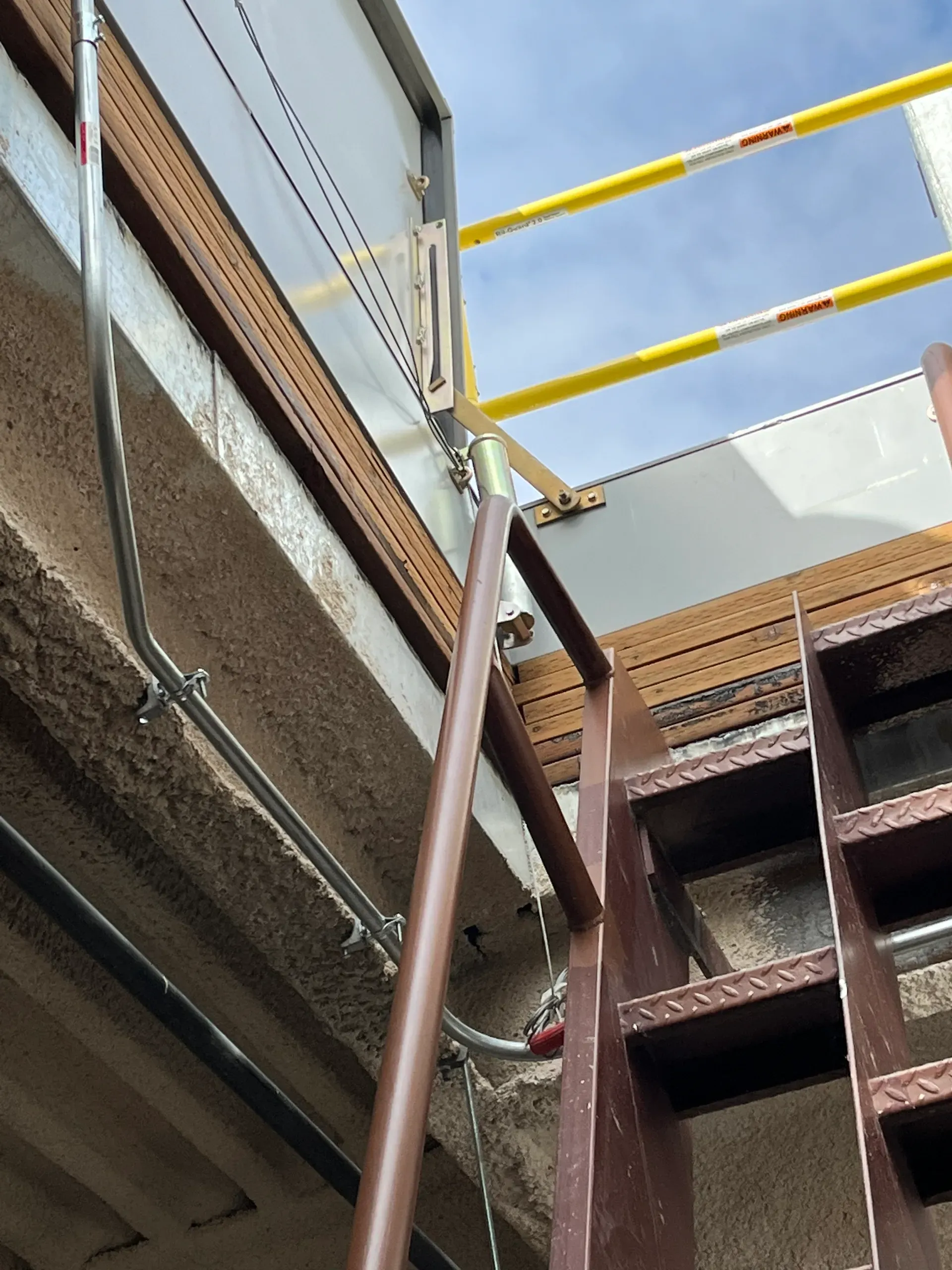 Interior stairwell view of a motorized hatch installation