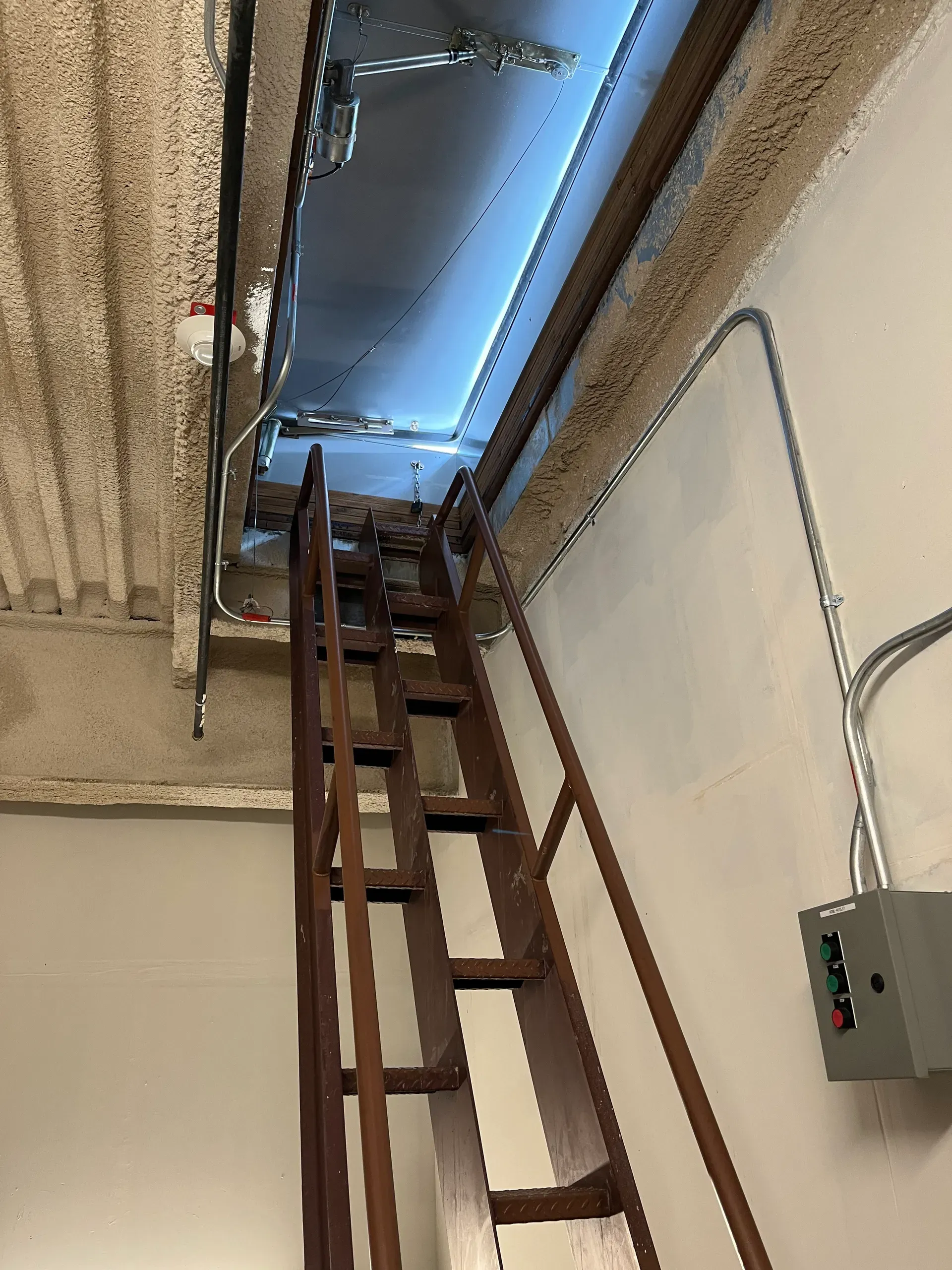 Control station and conduit near an access hatch stairwell